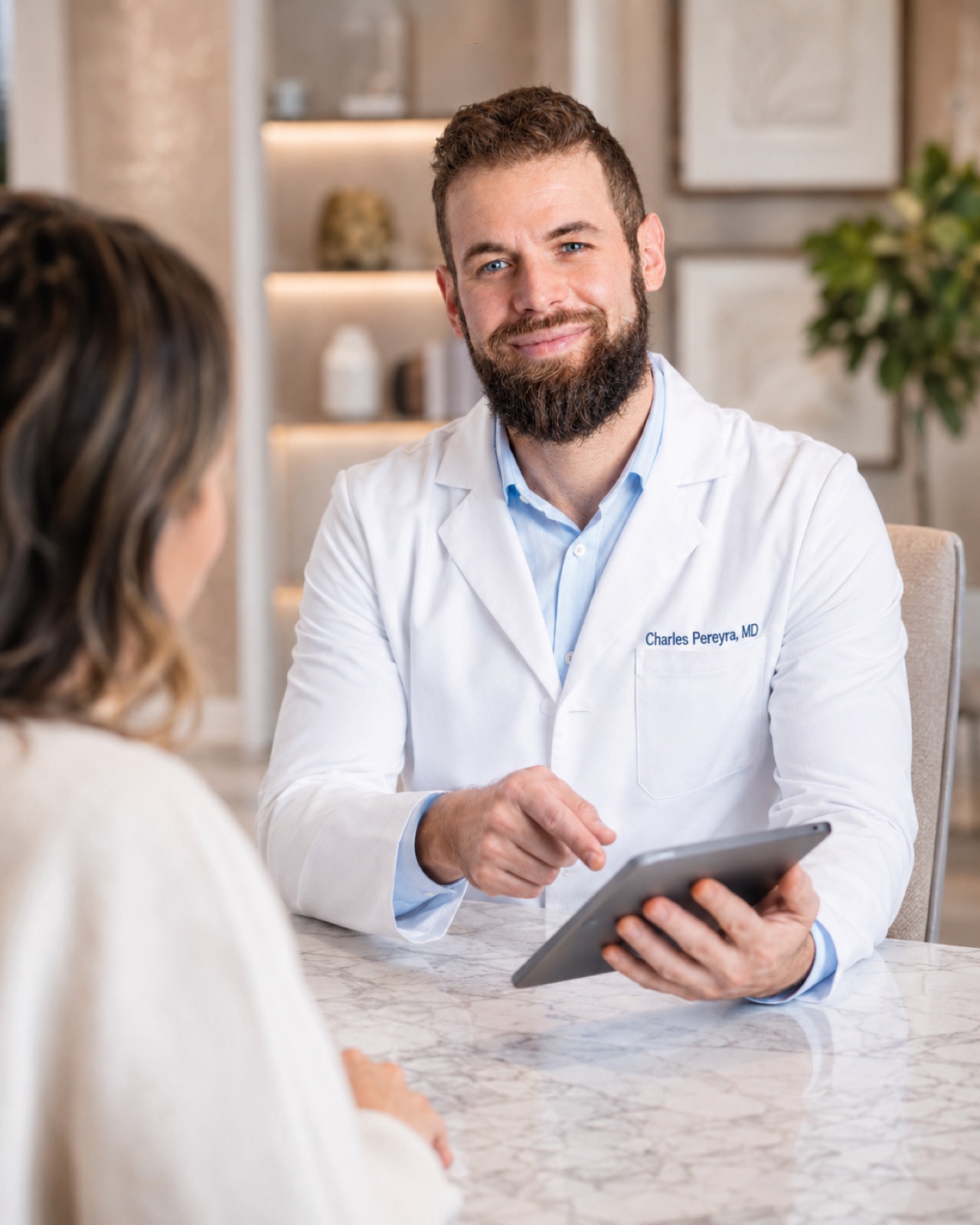 Dr. Charles Pereyra, MD consulting with a patient about regenerative care at Springs Rejuvenation in Miami